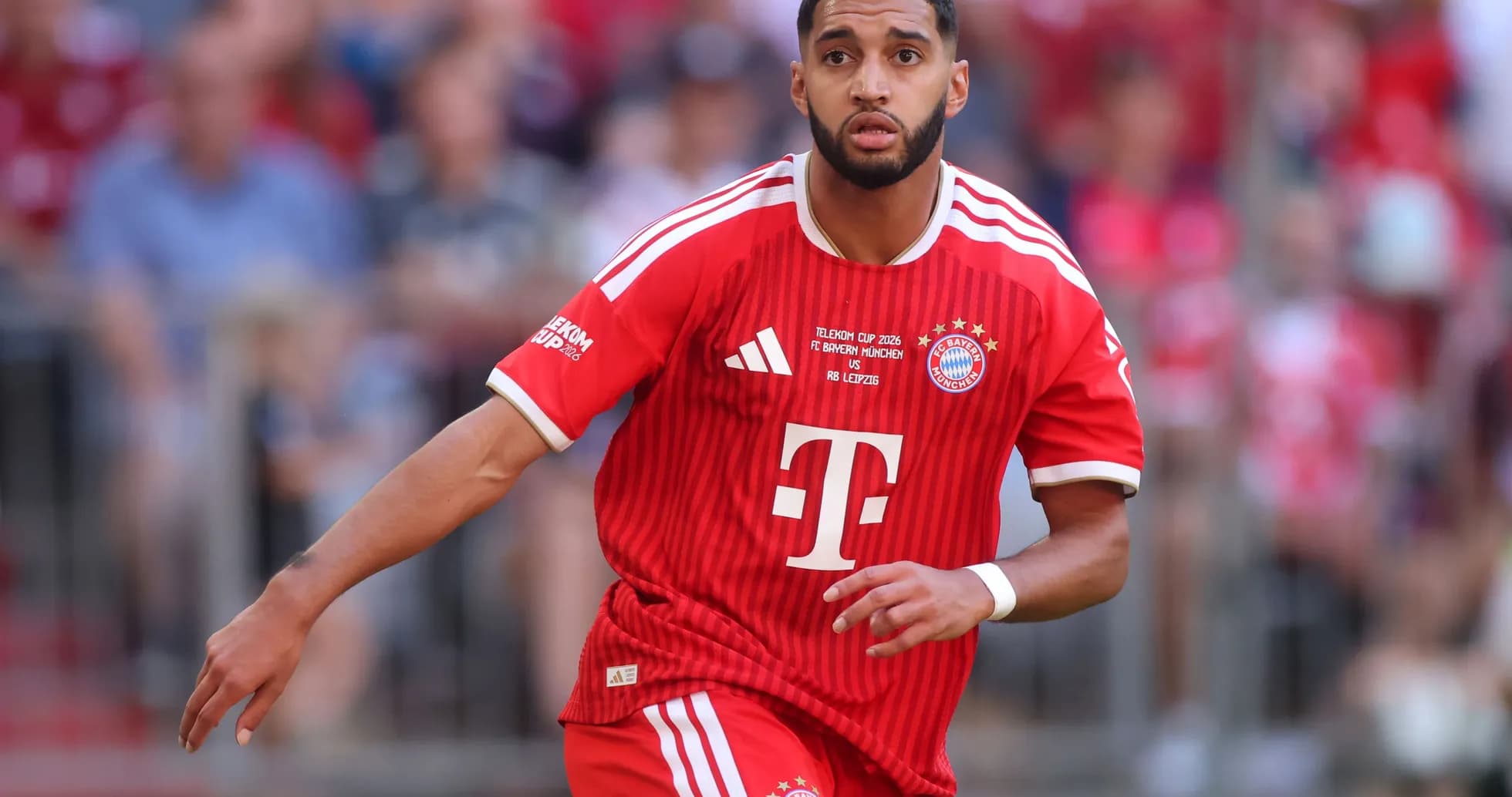 Player in red Bayern Munich kit running during match Player in red Bayern Munich kit running during match