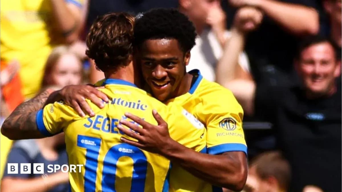 Two players celebrating a goal with a hug Two players celebrating a goal with a hug