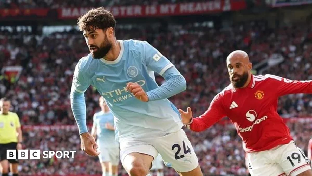 Manchester City player running with the ball against Manchester United Manchester City player running with the ball against Manchester United