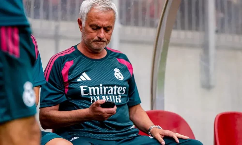 Coach checking phone on bench during match Coach checking phone on bench during match