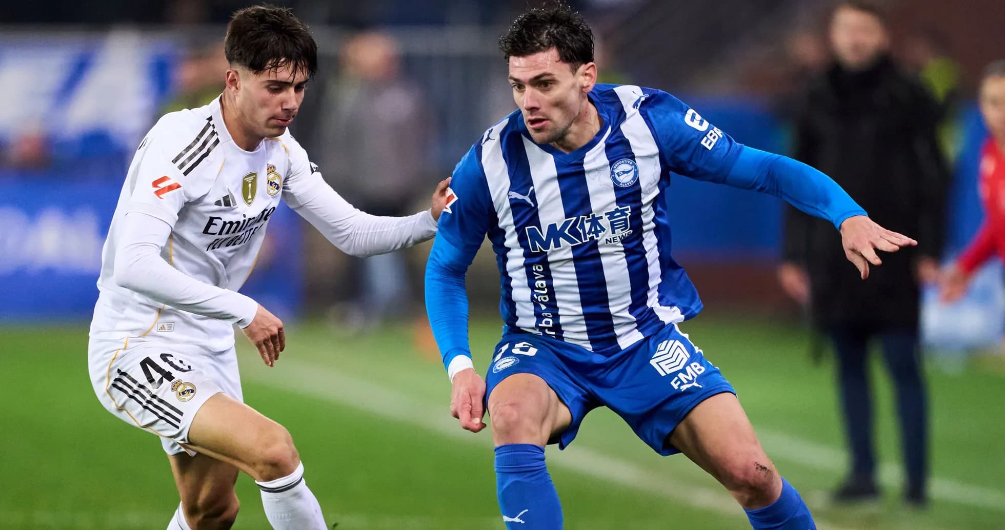 Two players contesting for the ball on the field Two players contesting for the ball on the field