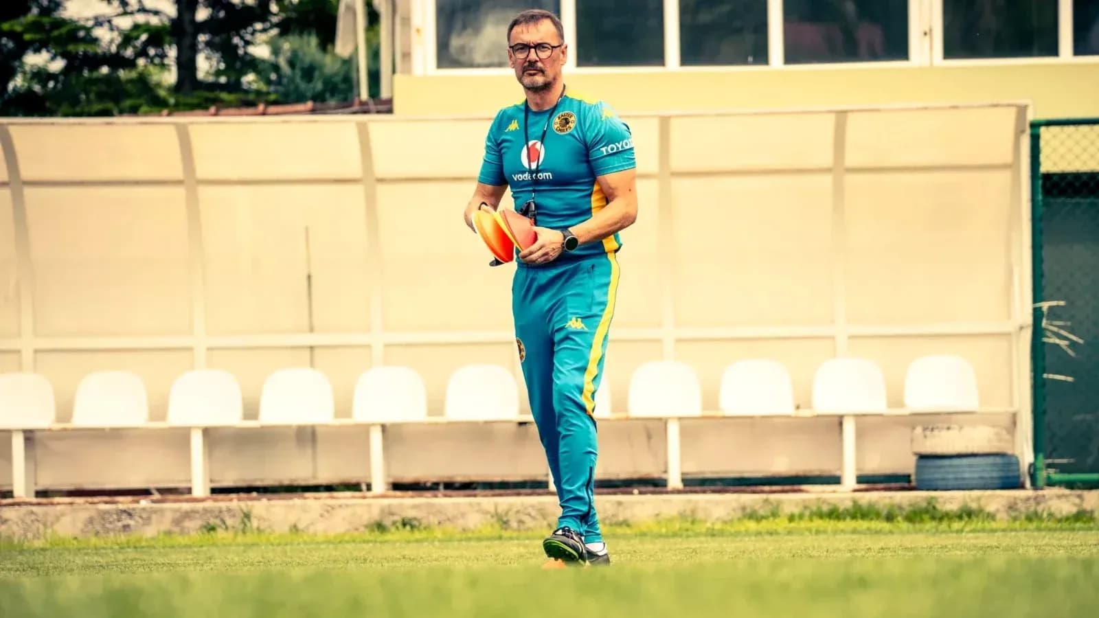 Coach holding training cones on field Coach holding training cones on field