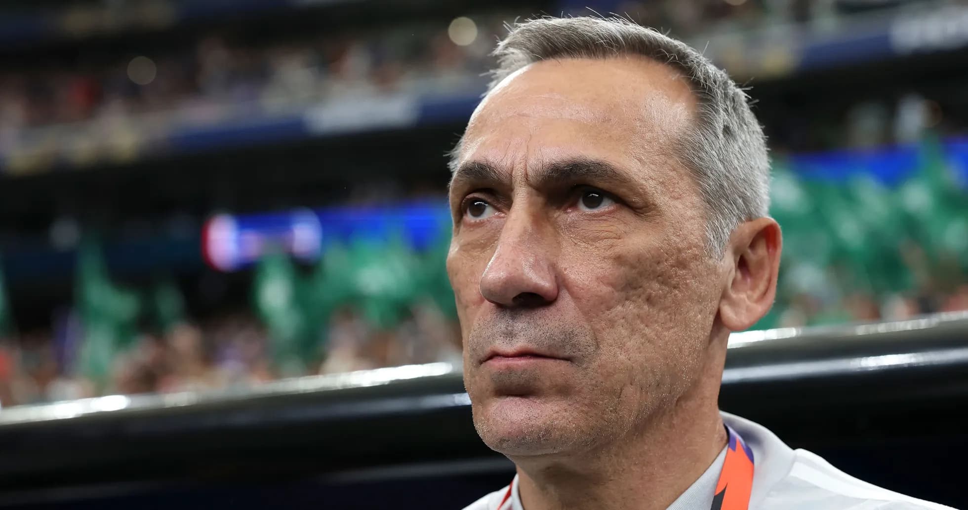 Coach focused during match in stadium environment Coach focused during match in stadium environment