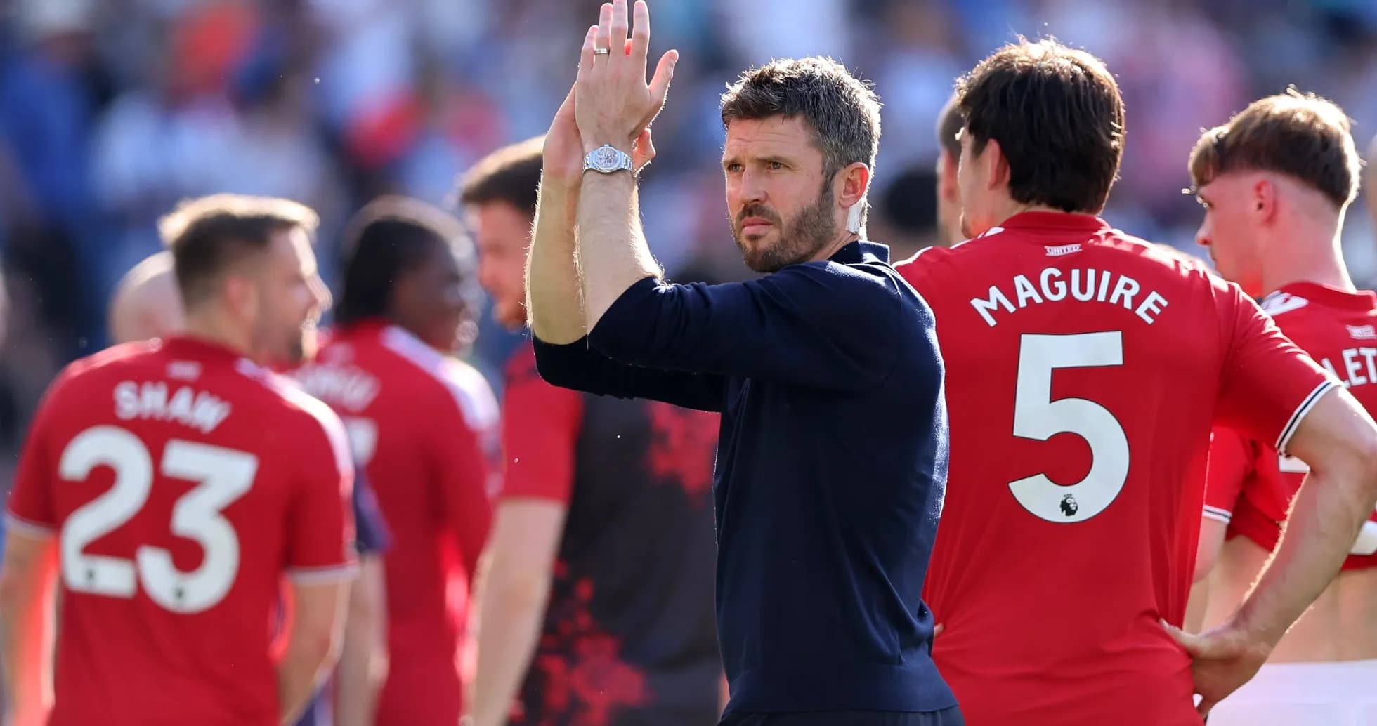 Manager applauding players after match in stadium Manager applauding players after match in stadium