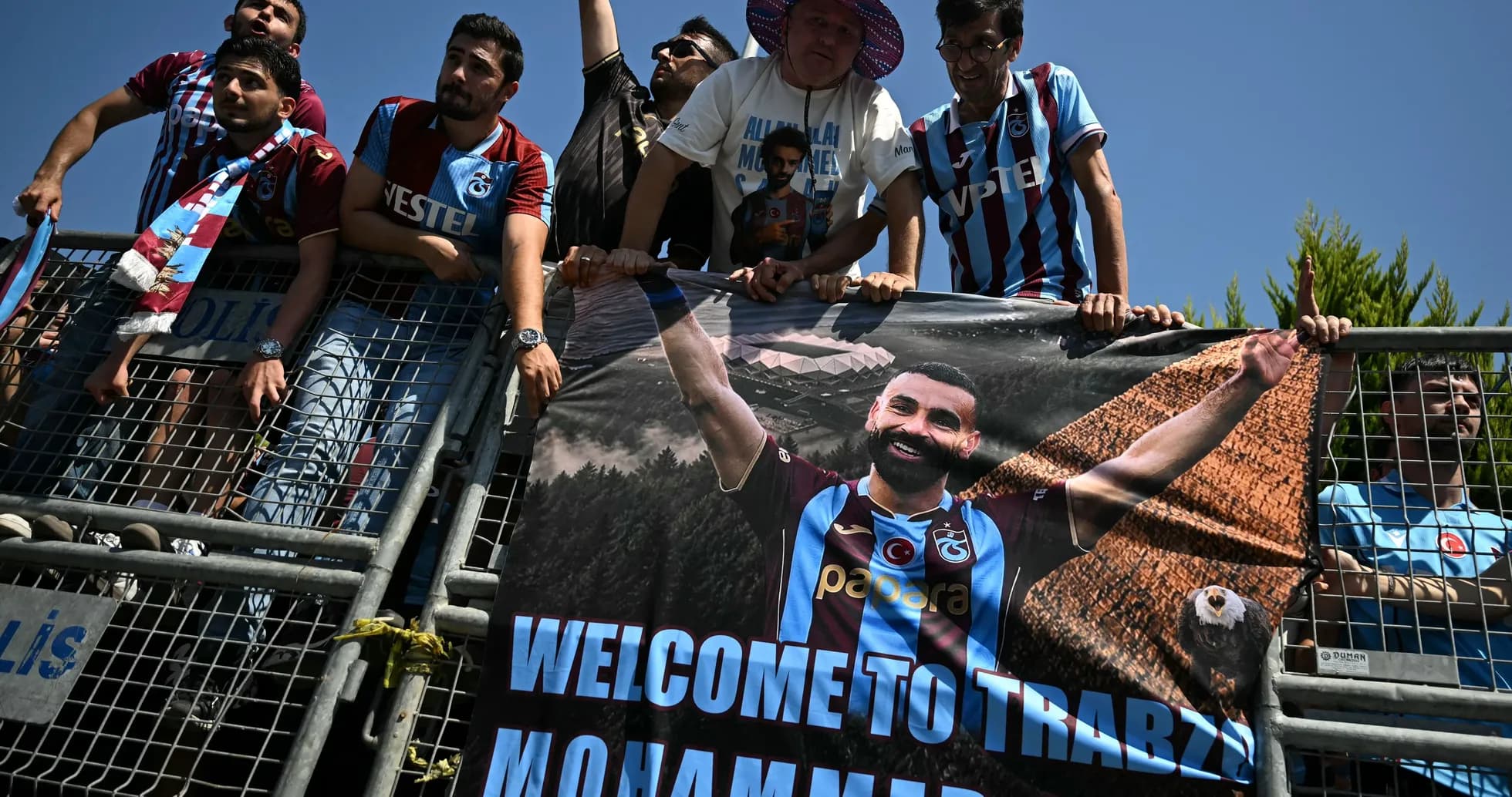 Fans holding a welcome banner for Mohammed Salah Fans holding a welcome banner for Mohammed Salah