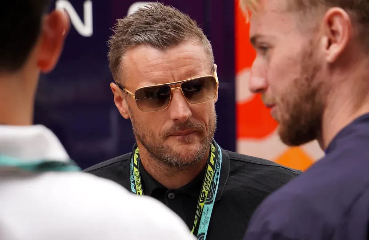 Man in sunglasses speaking with two others Man in sunglasses speaking with two others