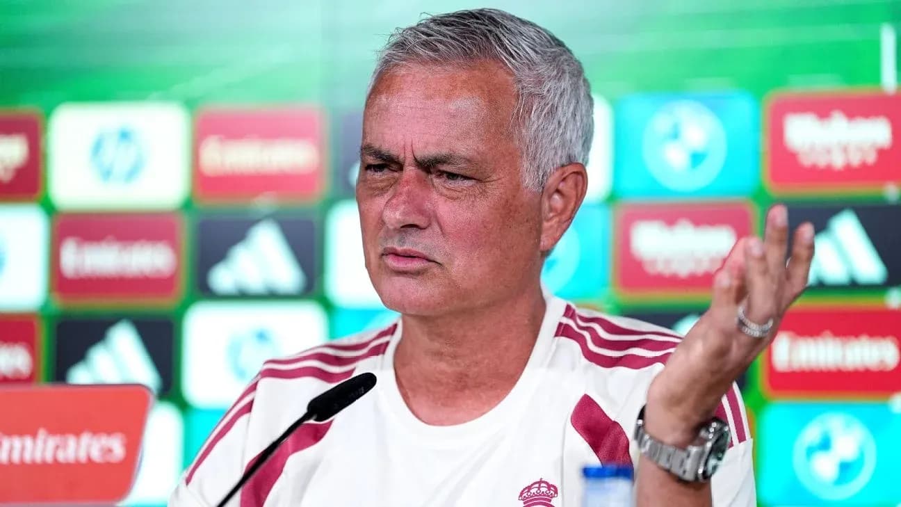 Manager speaking at press conference with logos behind Manager speaking at press conference with logos behind