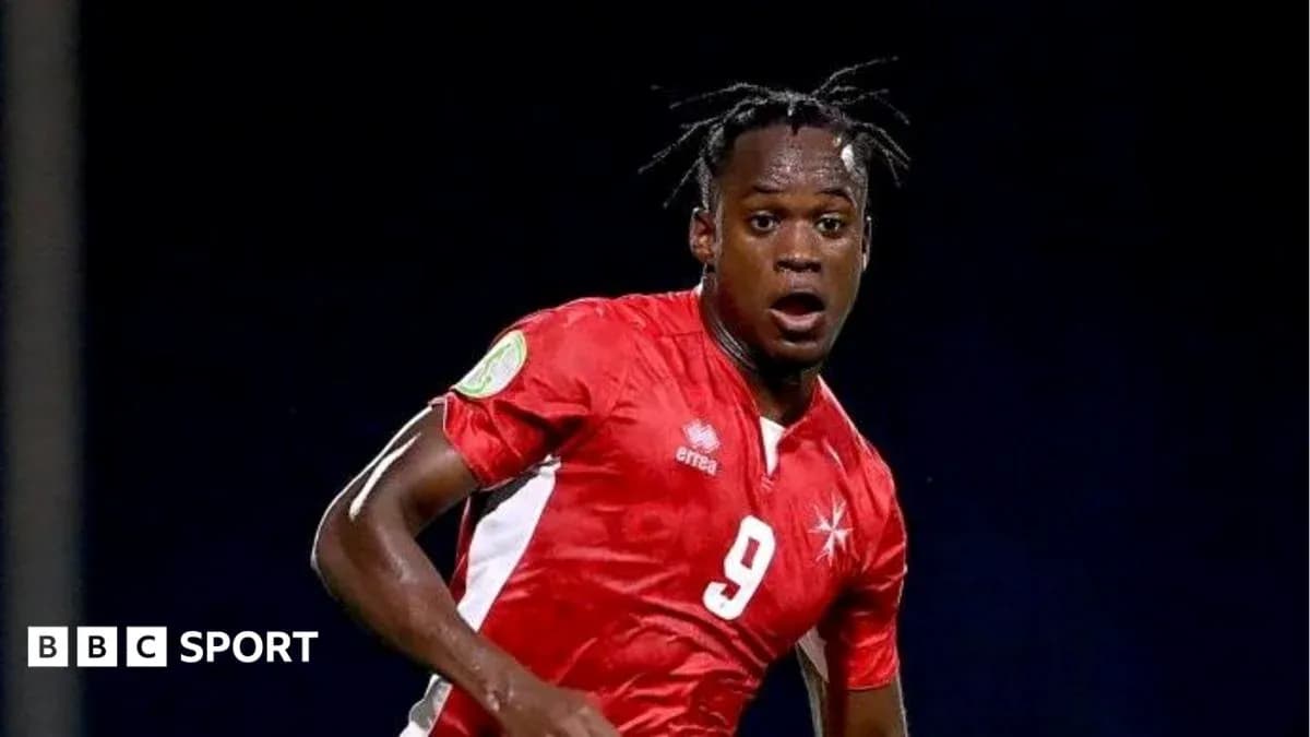 Player in red jersey during football match action Player in red jersey during football match action