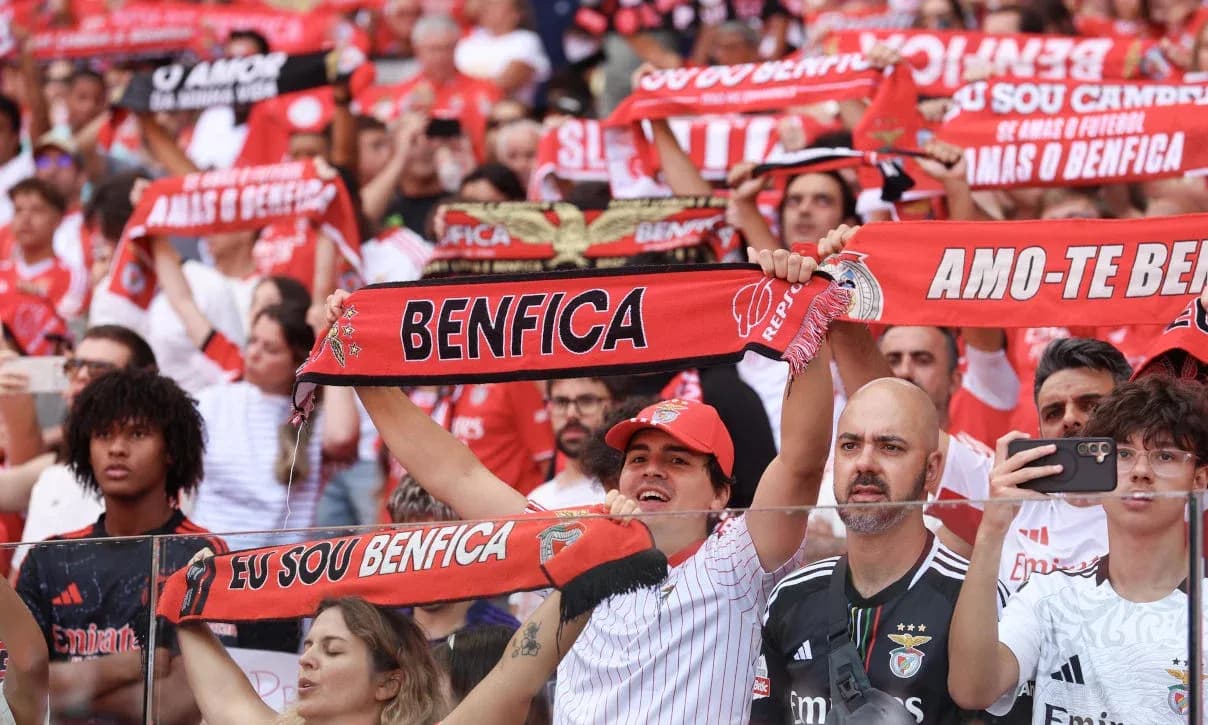 Benfica fans cheering with scarves in stadium Benfica fans cheering with scarves in stadium