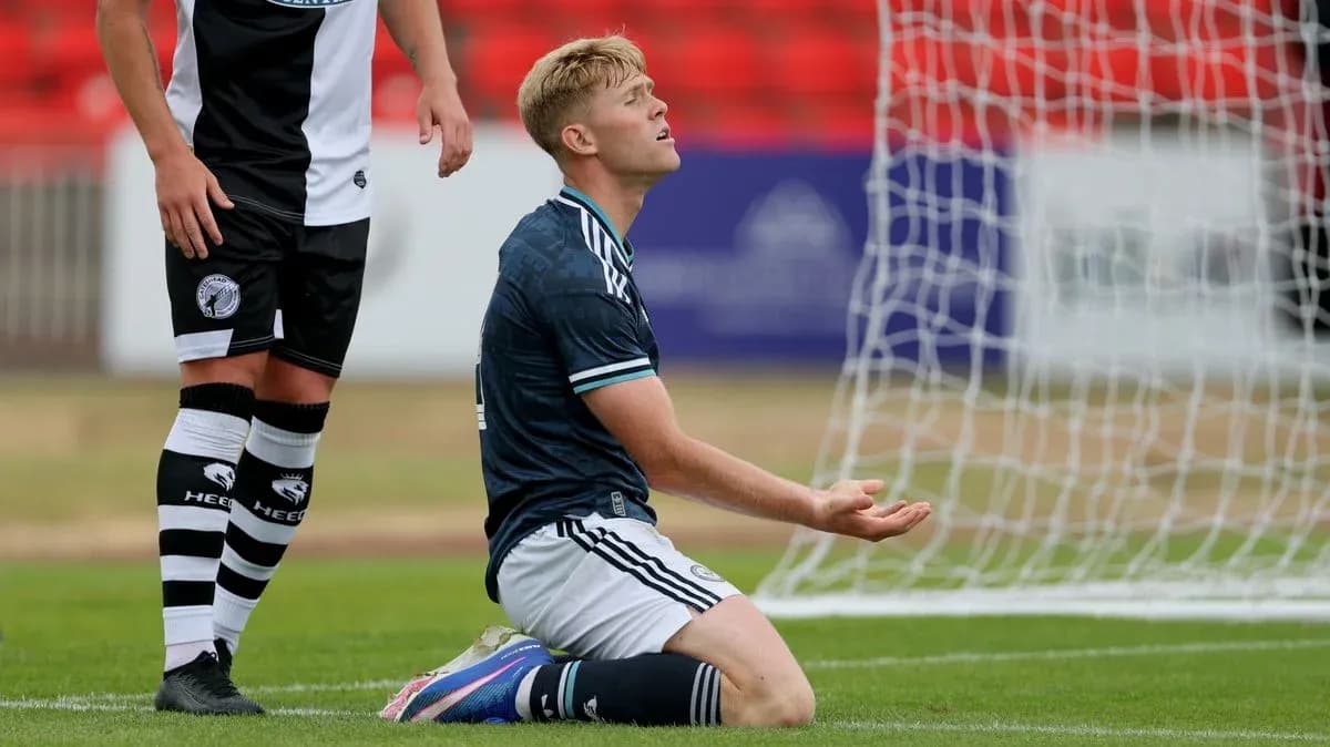 Player on knees in front of goal during match Player on knees in front of goal during match