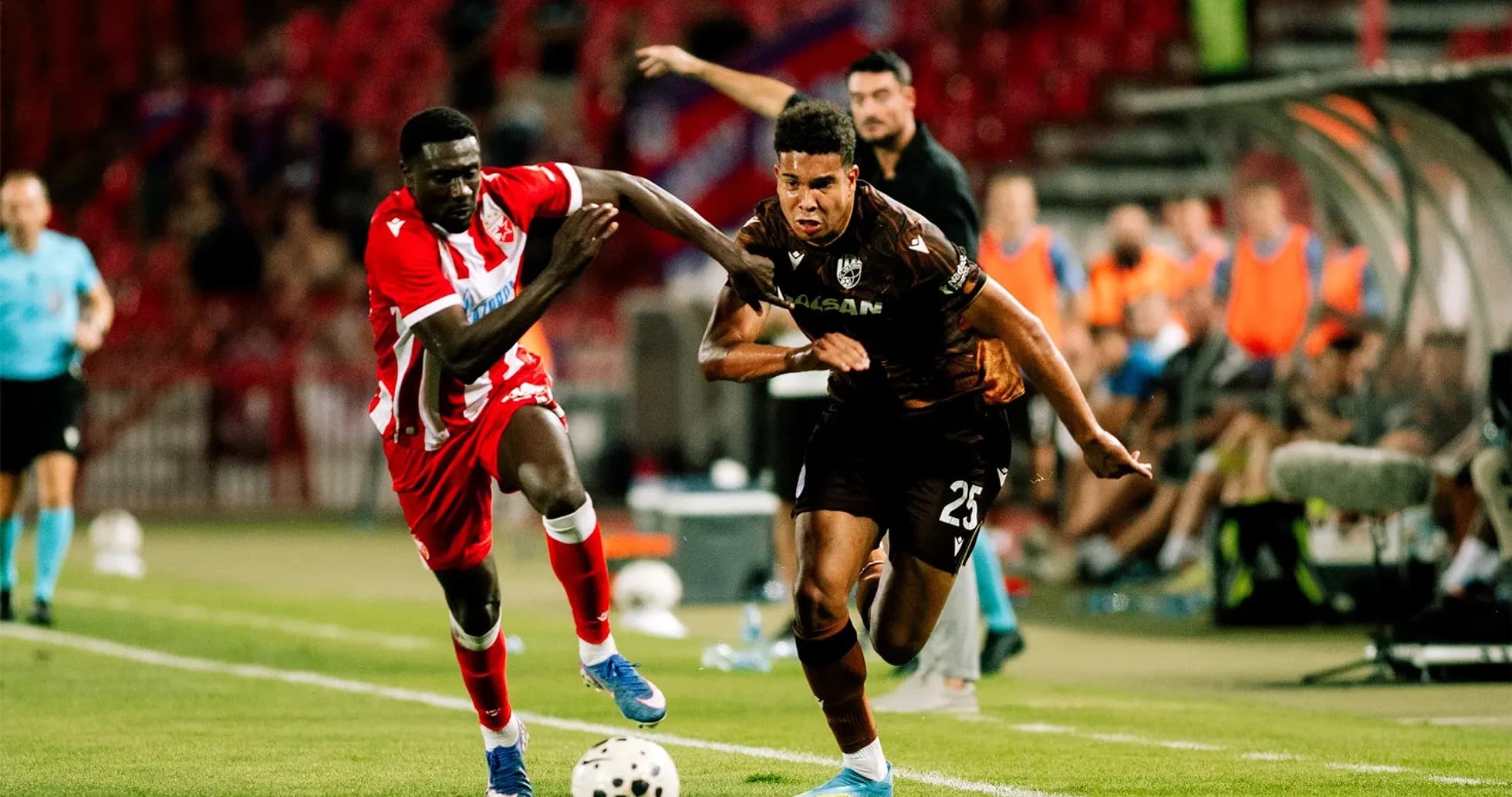 Player competing for the ball during UEFA match Player competing for the ball during UEFA match