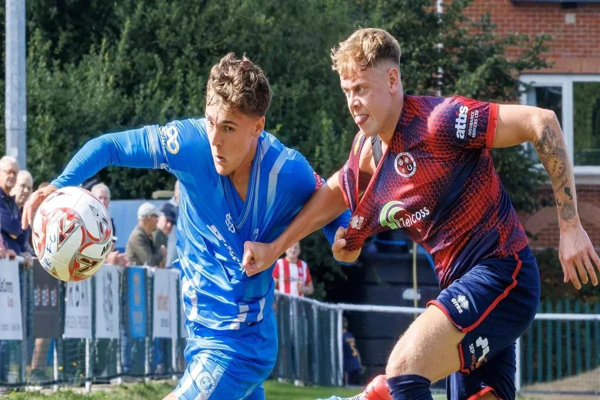 Two players competing for the ball in a match Two players competing for the ball in a match