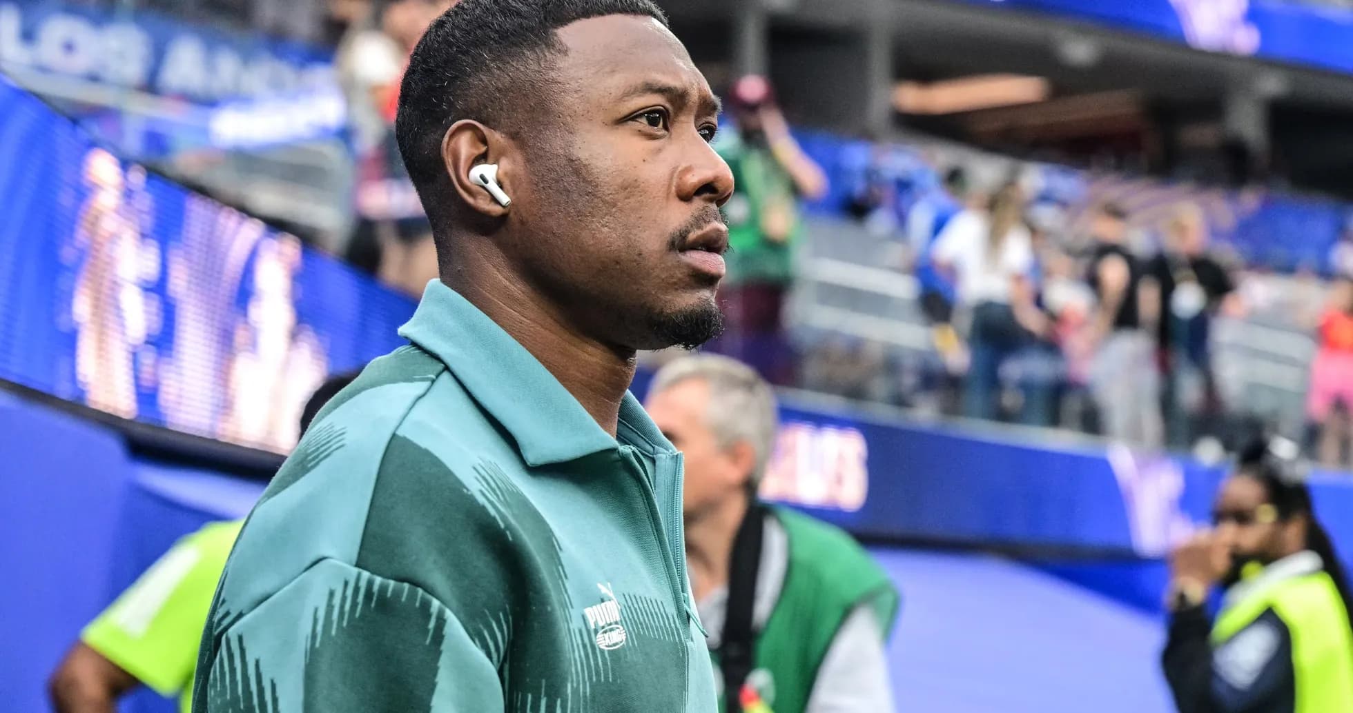 Player wearing earbuds on sidelines before match Player wearing earbuds on sidelines before match