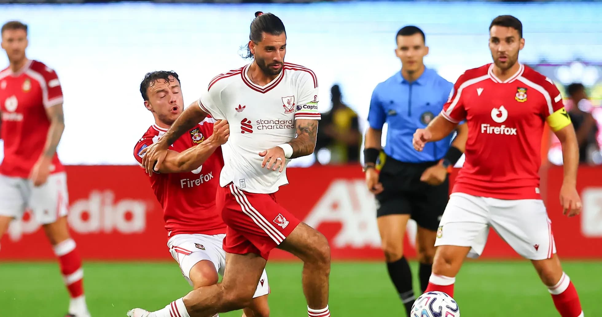 Player in white evading opponent during football match Player in white evading opponent during football match