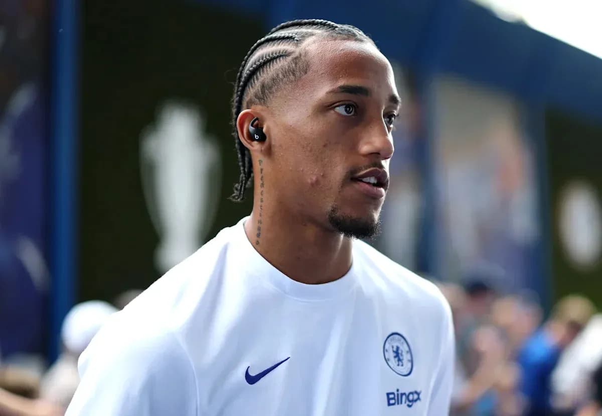 Player wearing Chelsea shirt with earbuds in stadium Player wearing Chelsea shirt with earbuds in stadium