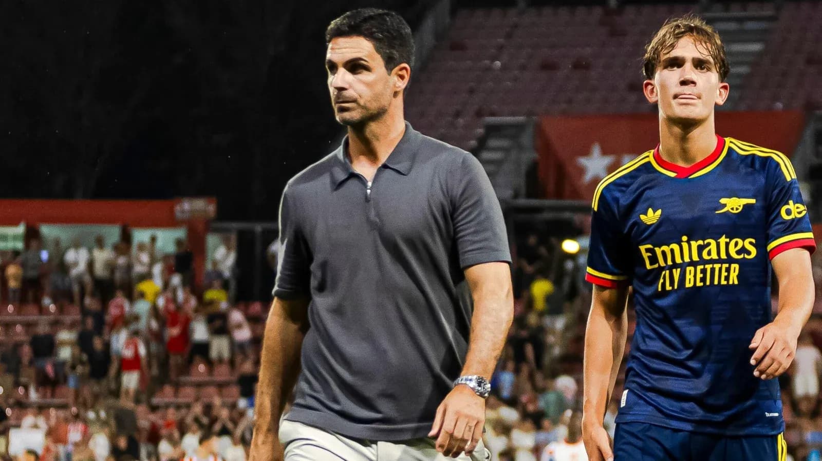 Manager and player walking off the pitch after match Manager and player walking off the pitch after match