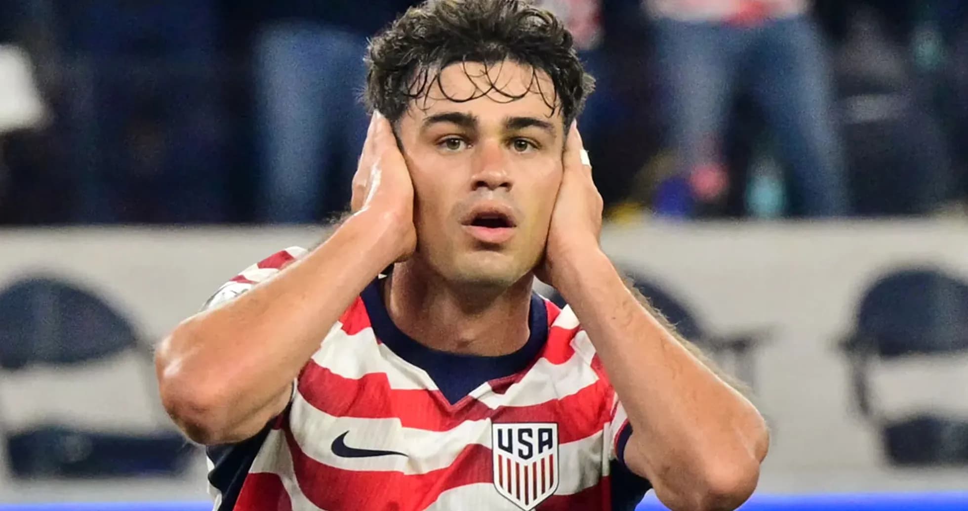 Player reacting during a soccer match wearing USA jersey Player reacting during a soccer match wearing USA jersey