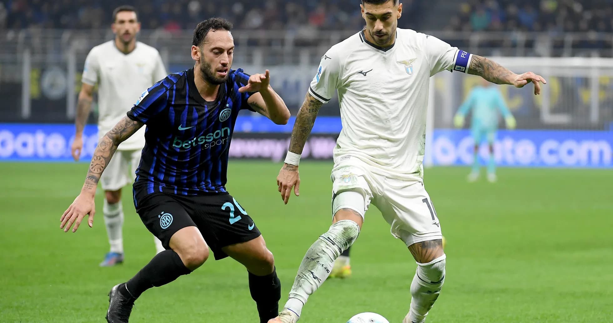 Lazio player dribbling past Inter opponent Lazio player dribbling past Inter opponent