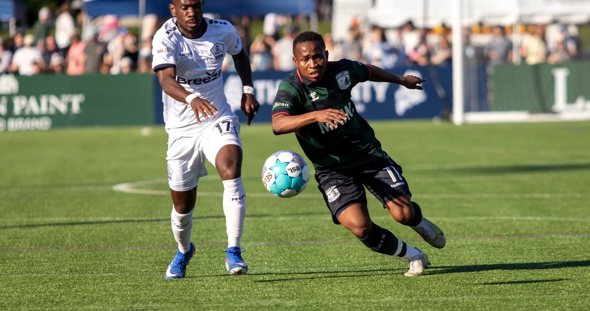 Players competing for the ball in USL match Players competing for the ball in USL match