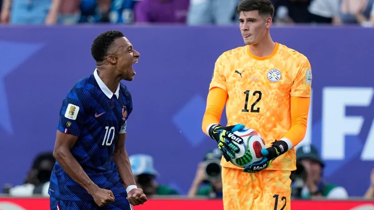 French player celebrating while goalkeeper holds ball French player celebrating while goalkeeper holds ball