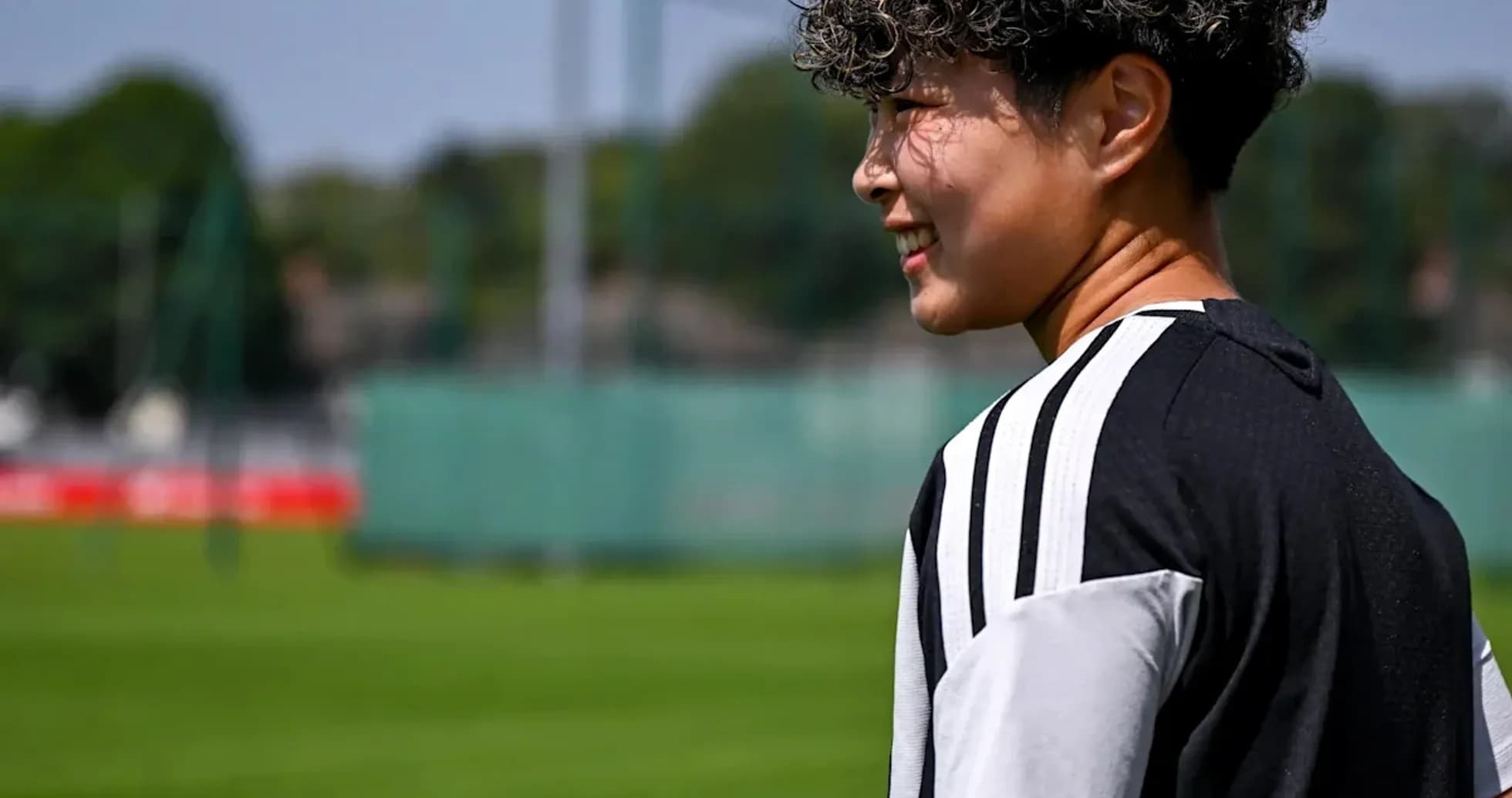 Player walking on training pitch with sunny background Player walking on training pitch with sunny background