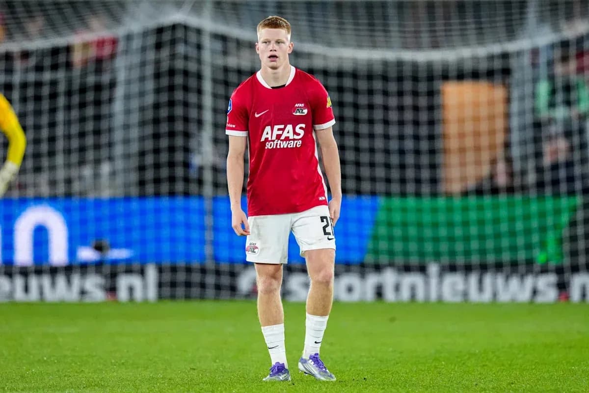 Player in red jersey standing on football pitch Player in red jersey standing on football pitch