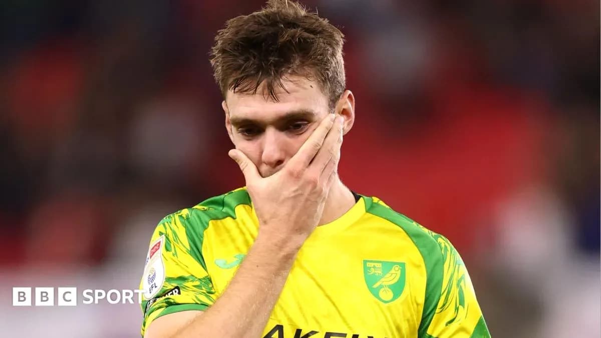 Player in yellow kit with hand on face Player in yellow kit with hand on face