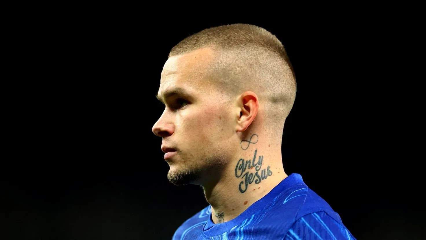 Player with tattoos wearing blue jersey, profile view Player with tattoos wearing blue jersey, profile view