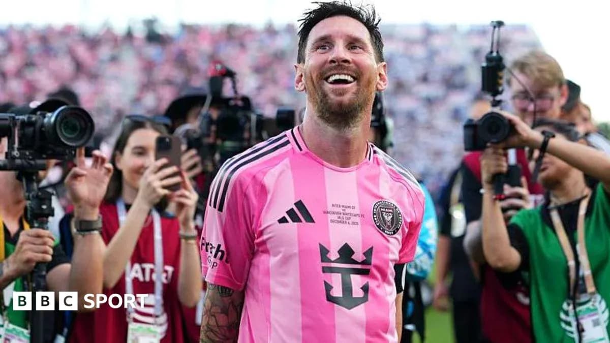 Lionel Messi smiling in pink jersey surrounded by fans Lionel Messi smiling in pink jersey surrounded by fans