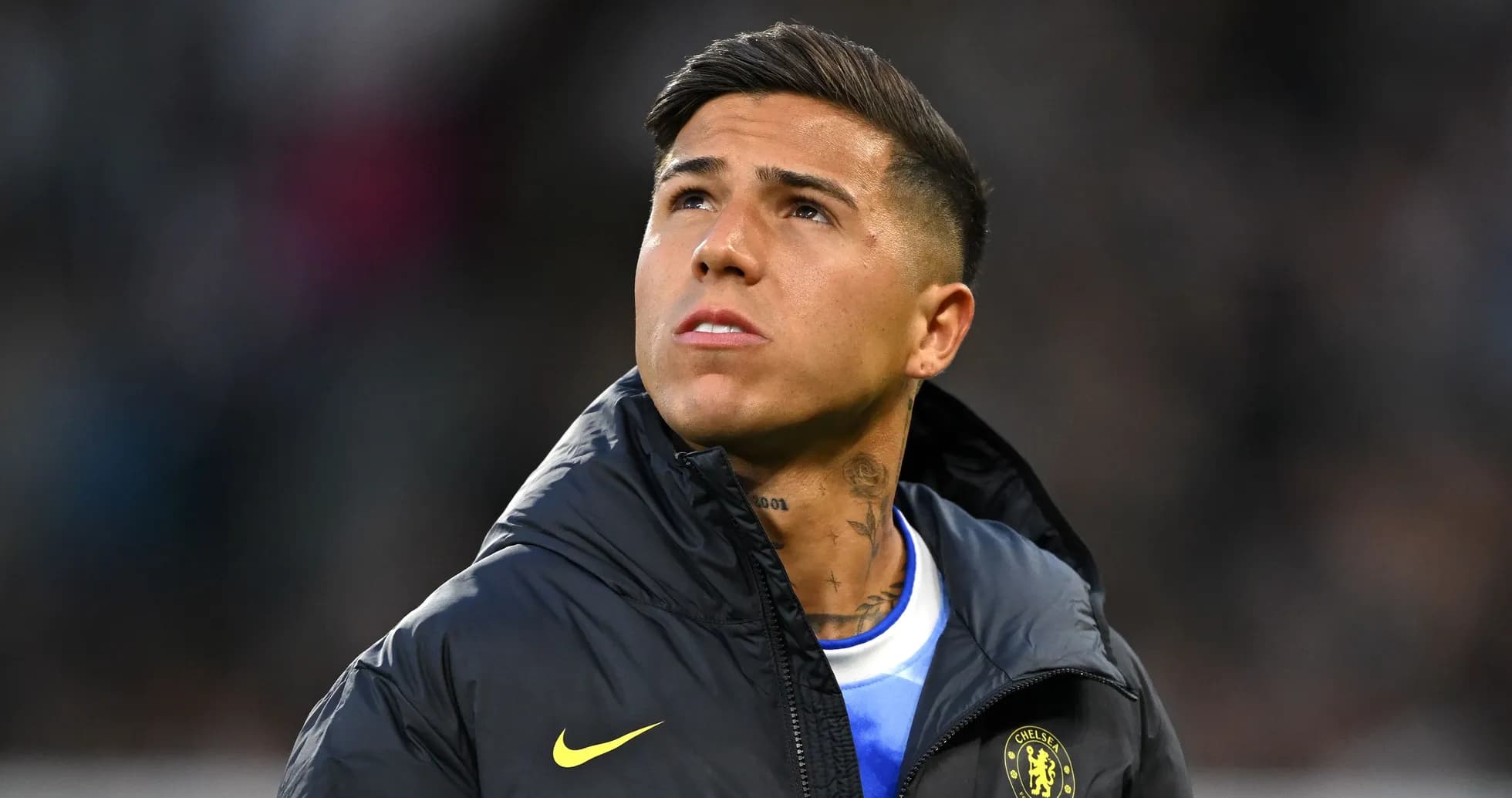 Player looking up while wearing team jacket Player looking up while wearing team jacket