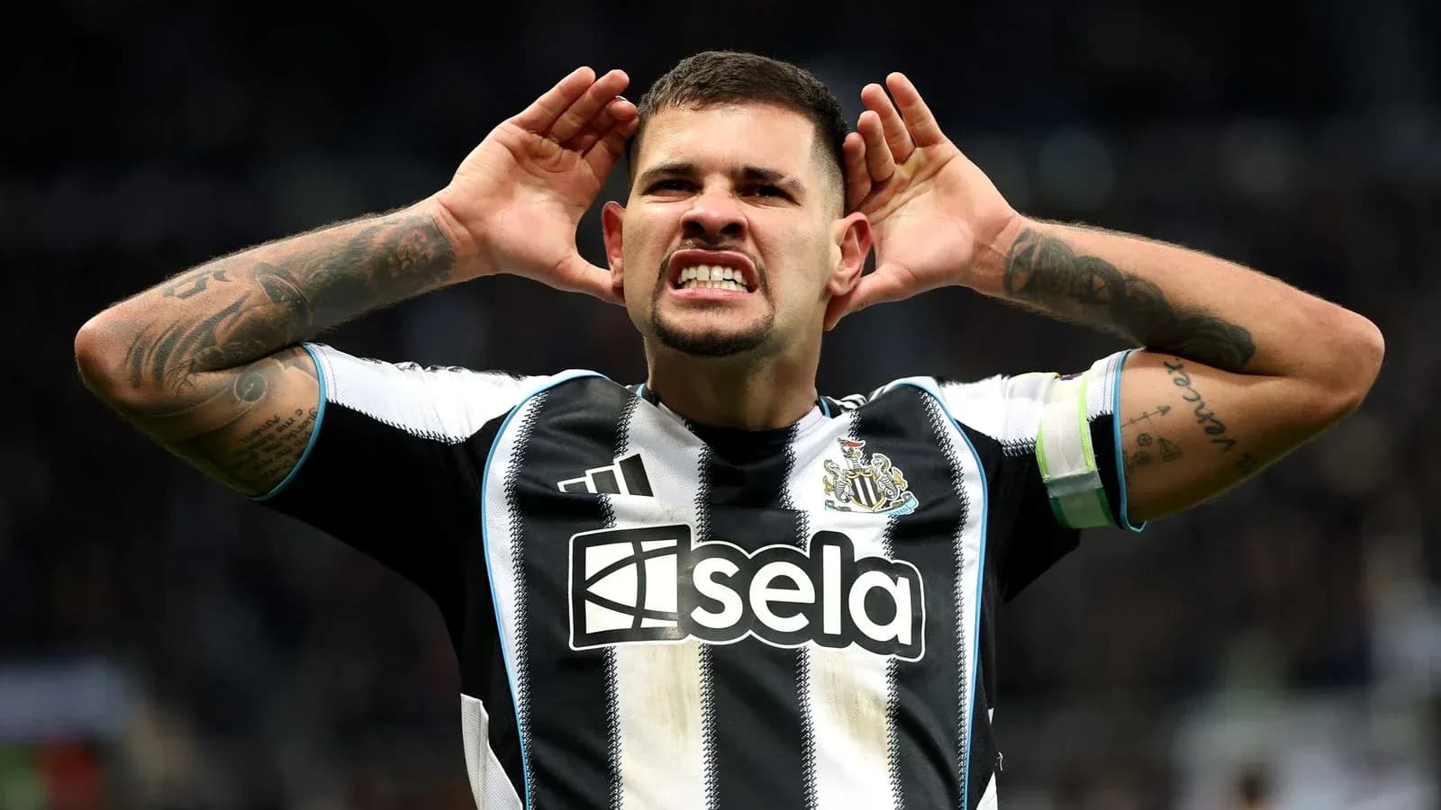 Player celebrating with hands on ears at stadium Player celebrating with hands on ears at stadium