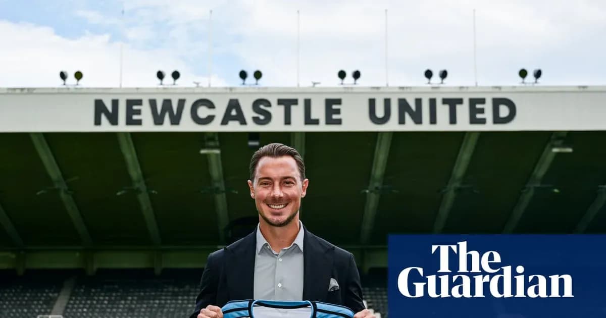 Newcastle United player holding team jersey outside stadium Newcastle United player holding team jersey outside stadium