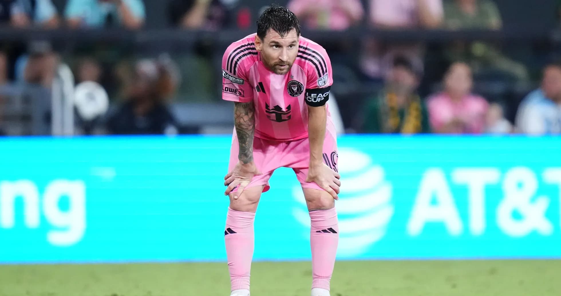 Player in pink uniform resting during match Player in pink uniform resting during match