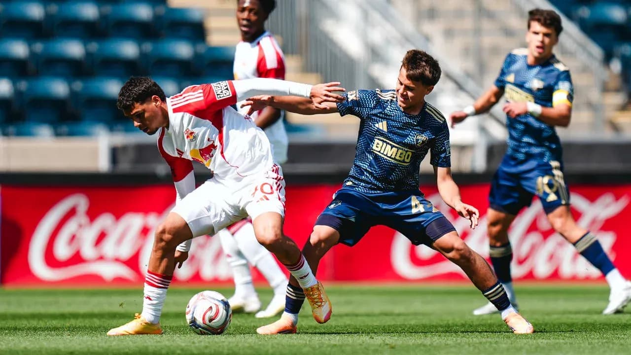 New York Red Bulls player challenged by Philadelphia Union opponent New York Red Bulls player challenged by Philadelphia Union opponent