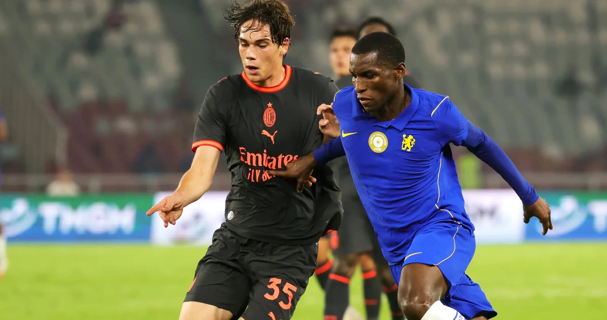 Players from AC Milan and Chelsea competing for possession Players from AC Milan and Chelsea competing for possession