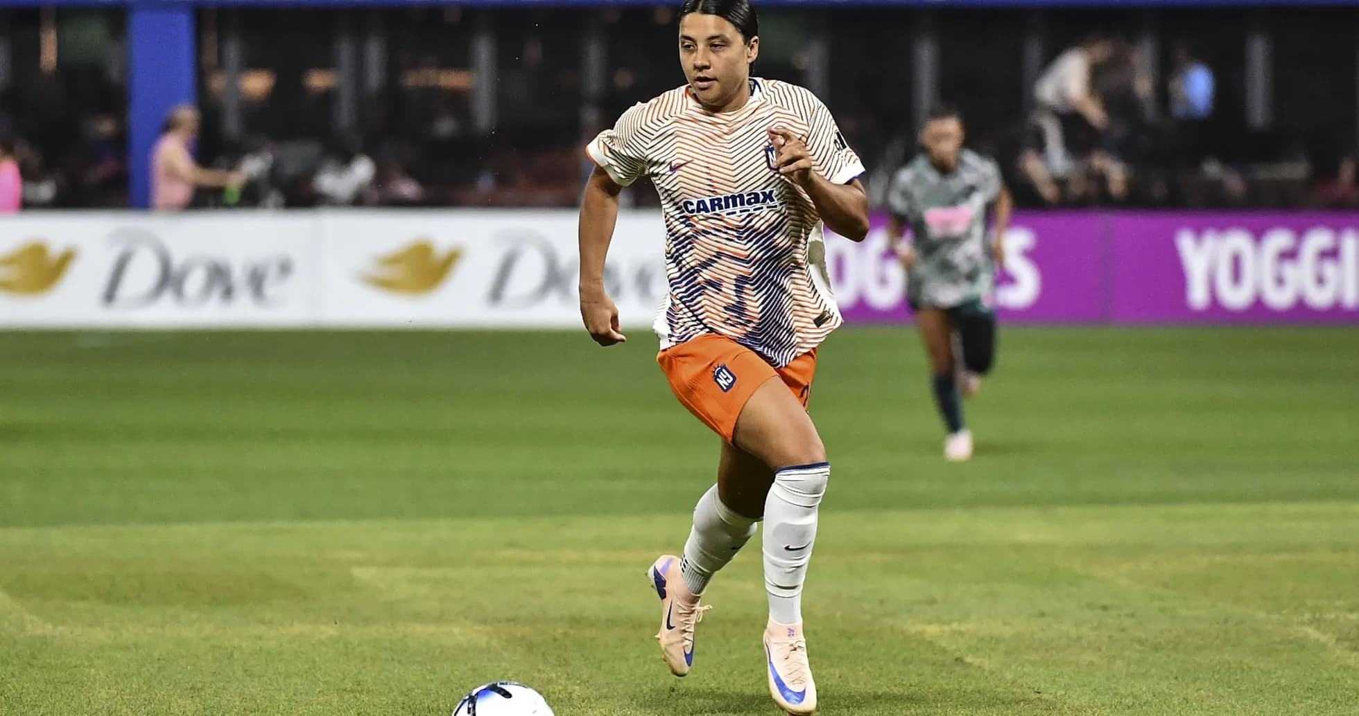 Player sprinting with ball during soccer match Player sprinting with ball during soccer match