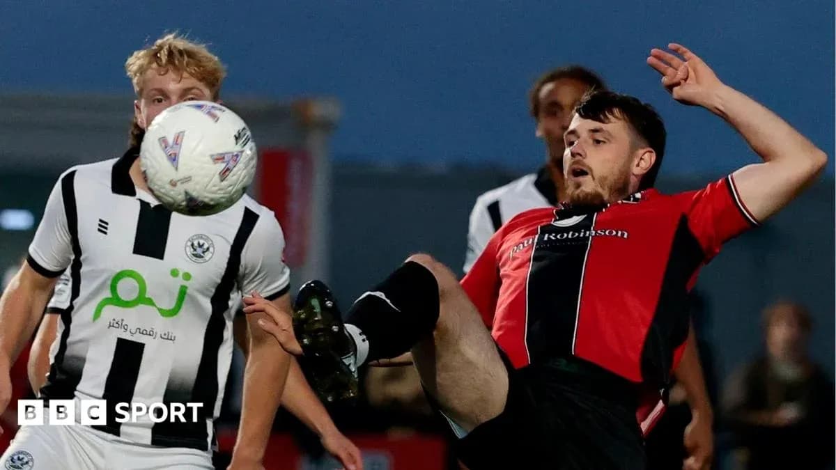 Player kicking ball during a competitive match Player kicking ball during a competitive match