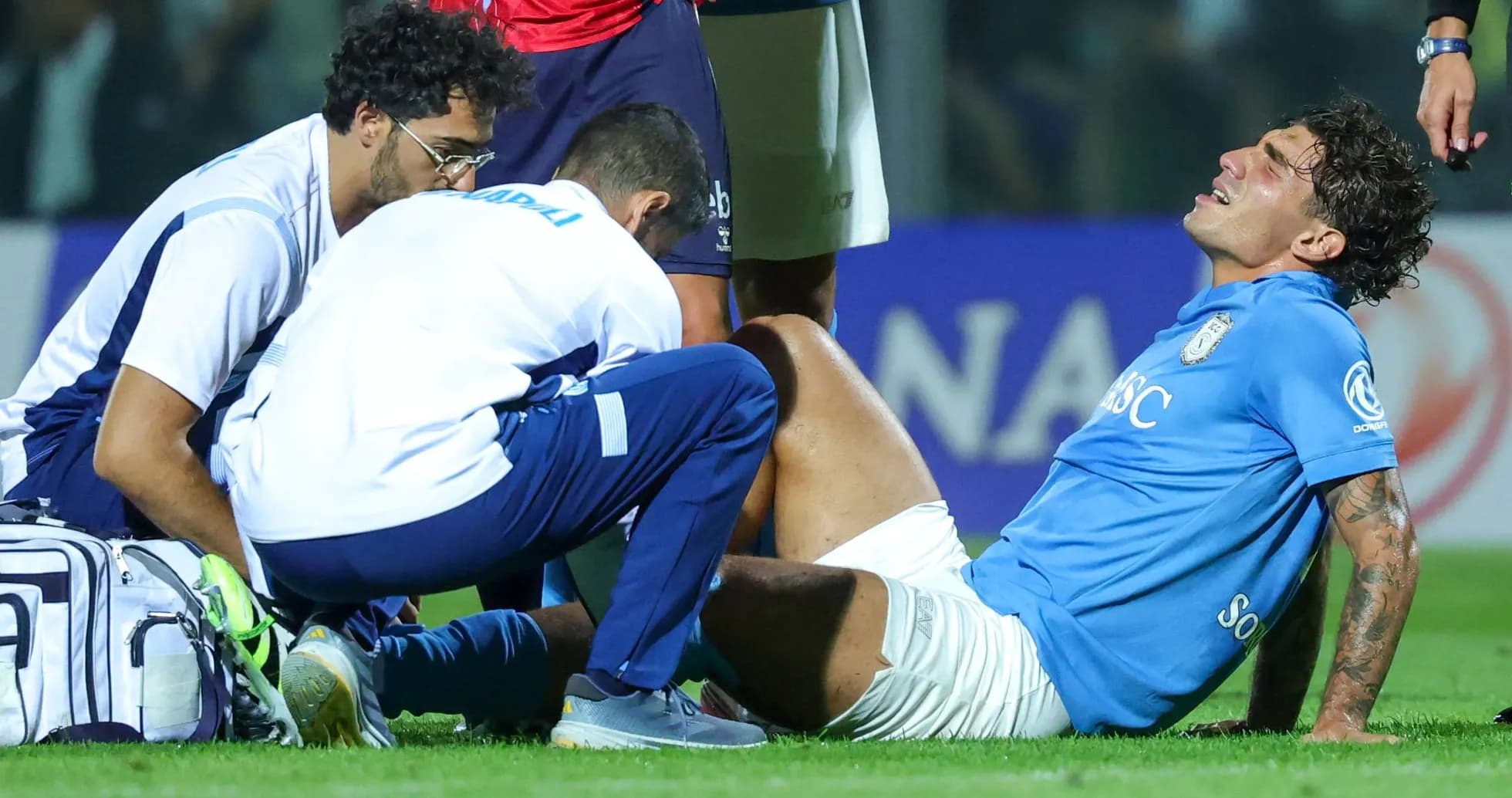 Player receiving medical attention on the field Player receiving medical attention on the field