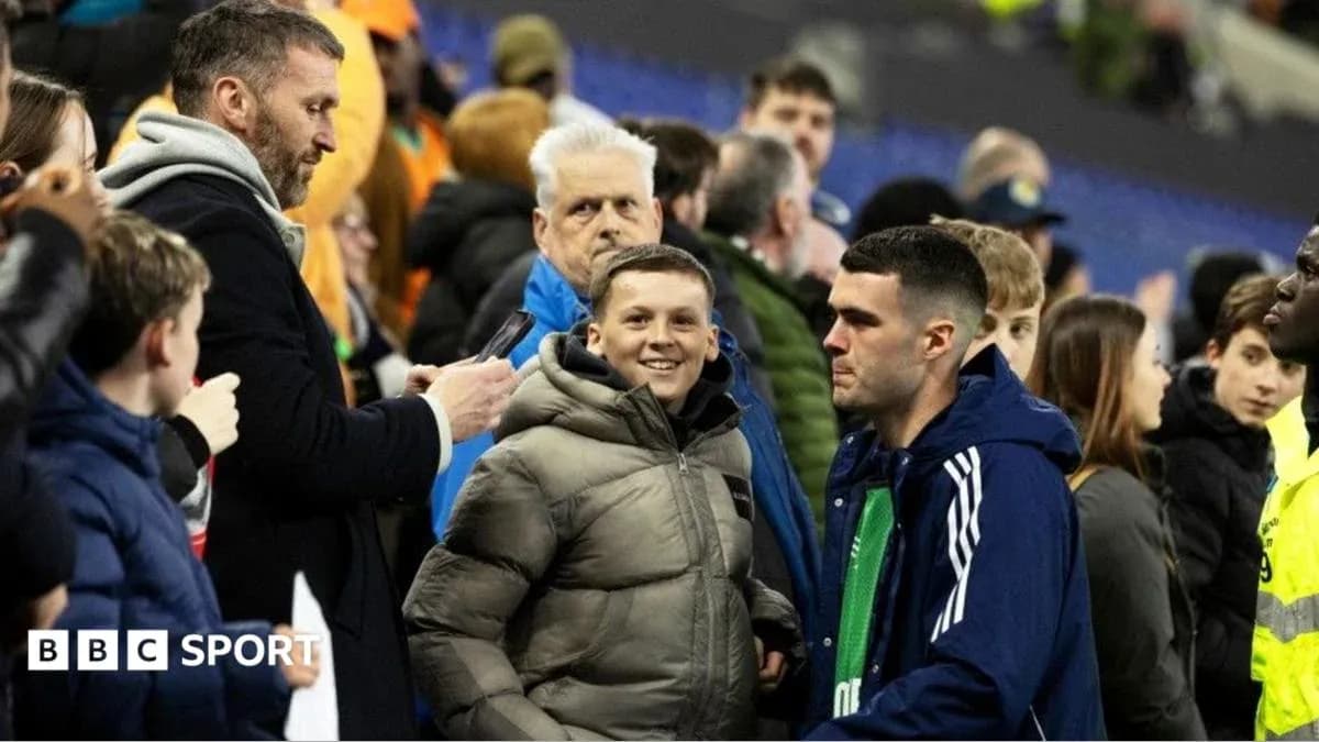 Fans interacting in the stands at a match Fans interacting in the stands at a match