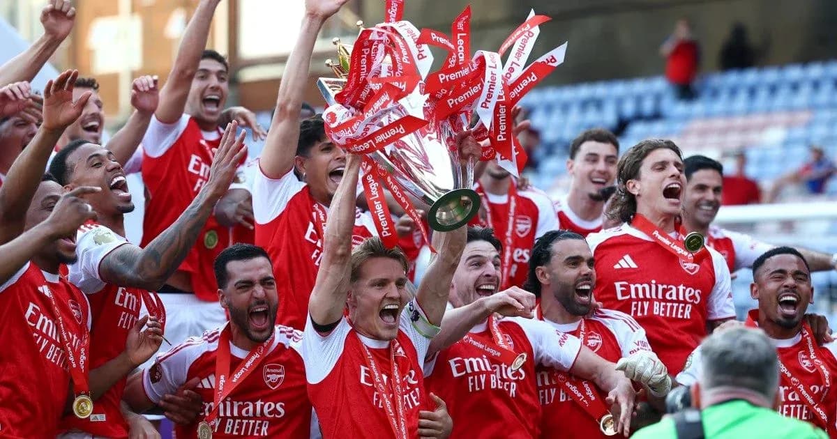 Arsenal players celebrating with Premier League trophy Arsenal players celebrating with Premier League trophy