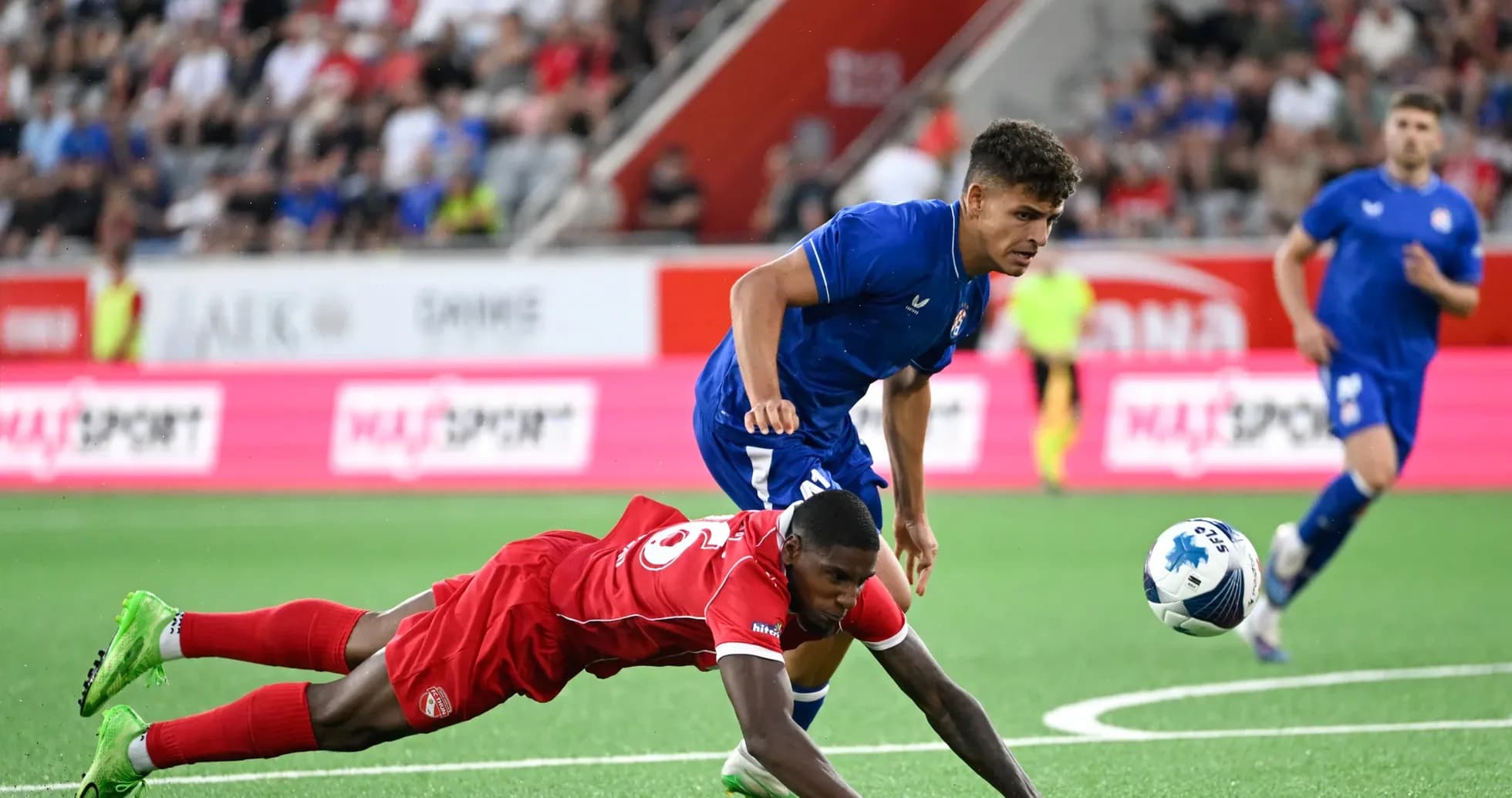 Dinamo Zagreb player challenging FC Thun opponent Dinamo Zagreb player challenging FC Thun opponent