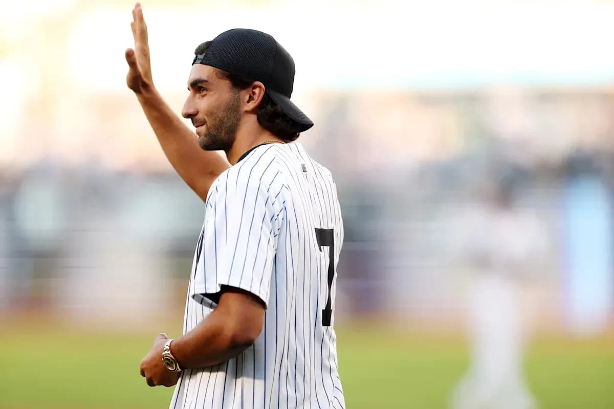 Man in Yankees jersey waving during game Man in Yankees jersey waving during game