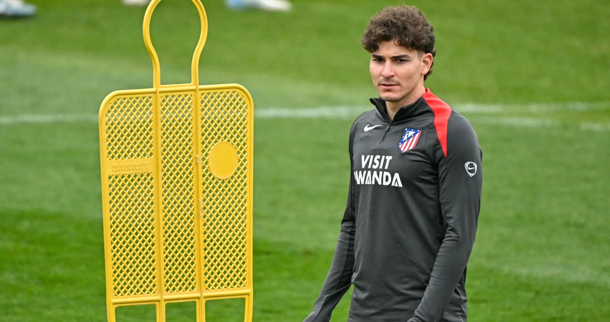 Player standing near training equipment at practice Player standing near training equipment at practice