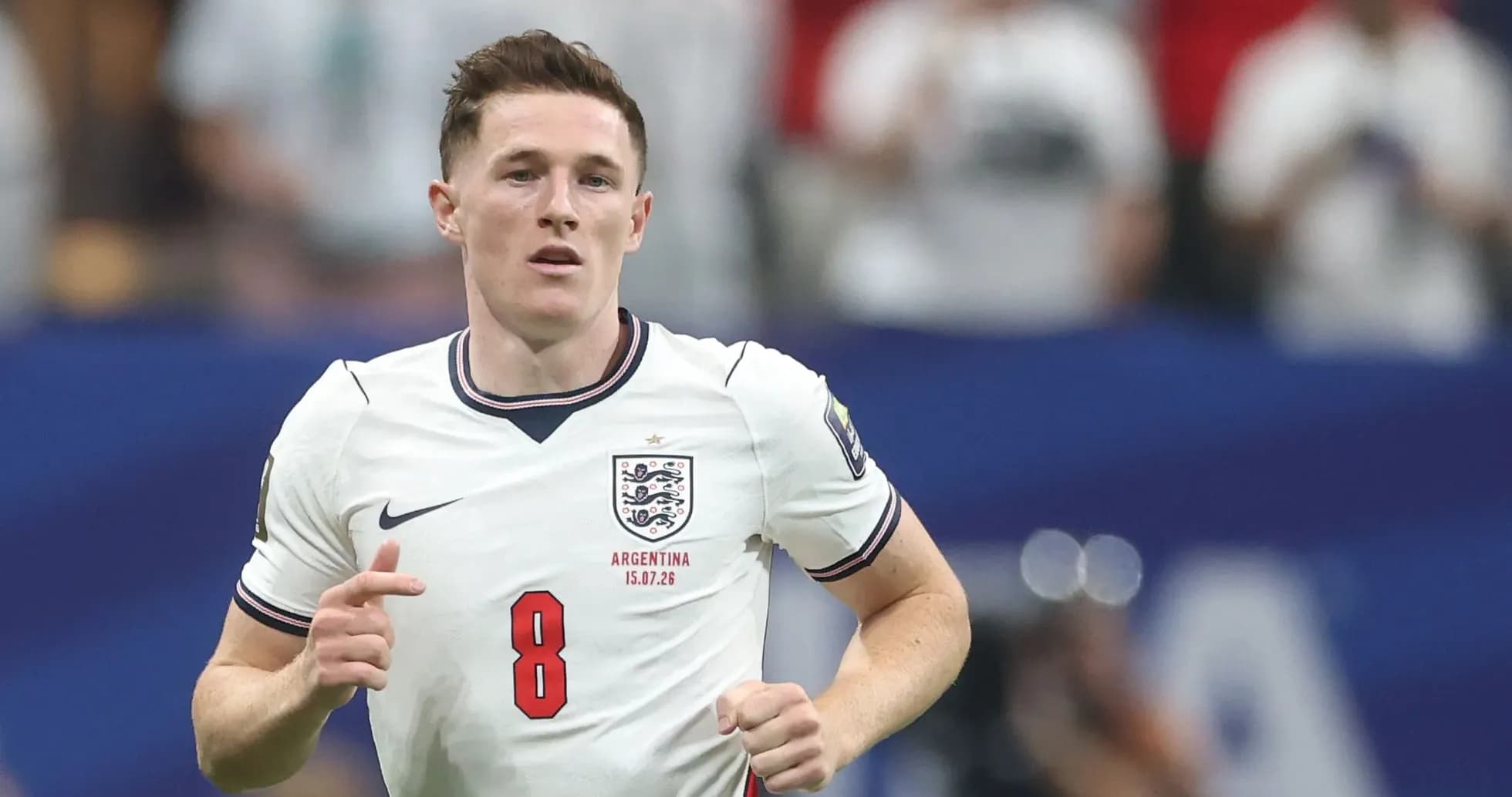 Player in England jersey running on the pitch Player in England jersey running on the pitch