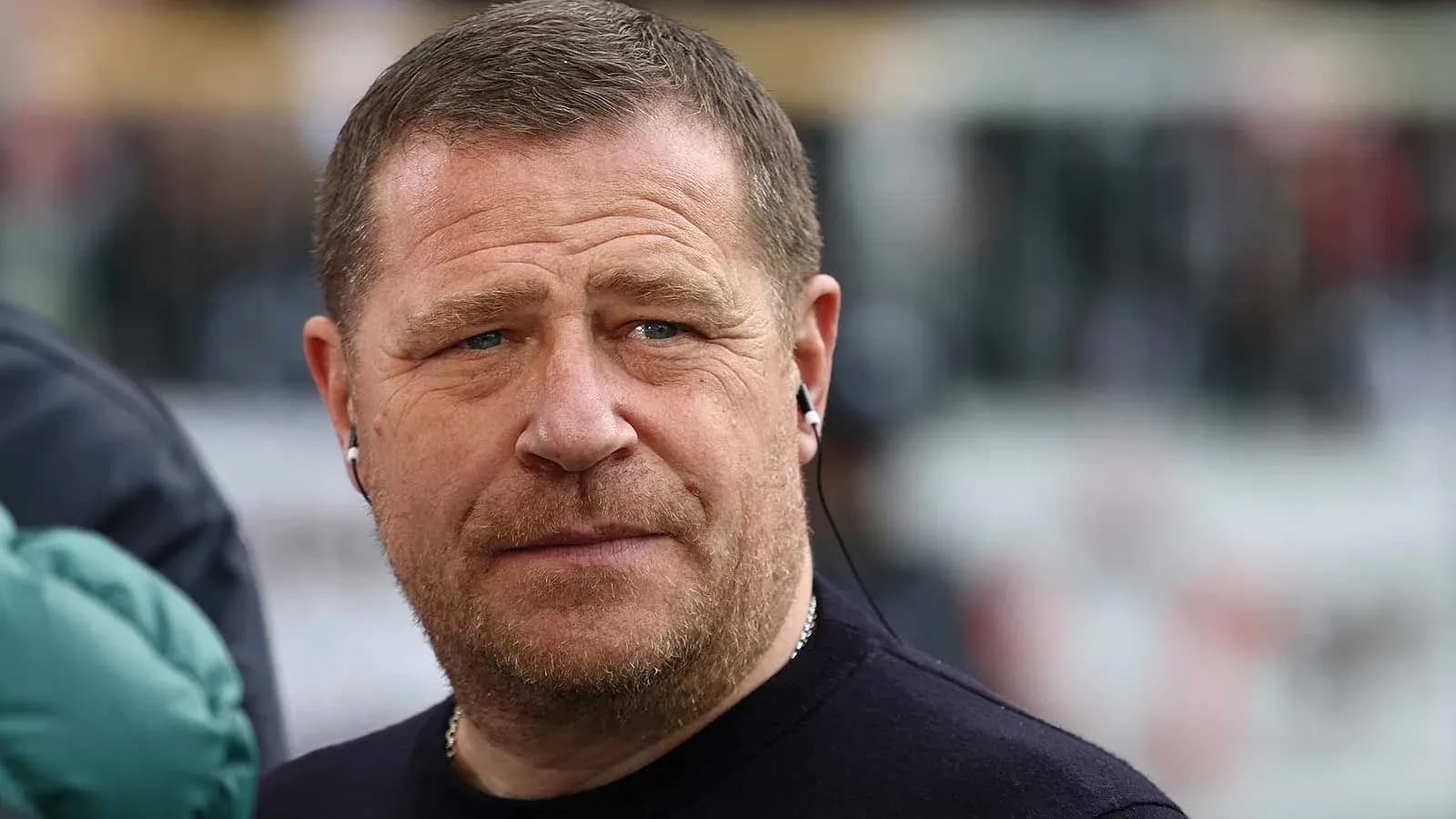 Man wearing earphones, looking intently at event Man wearing earphones, looking intently at event