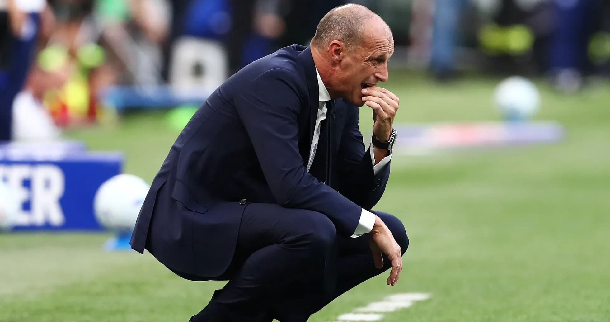 Coach crouched on the sidelines during a match Coach crouched on the sidelines during a match