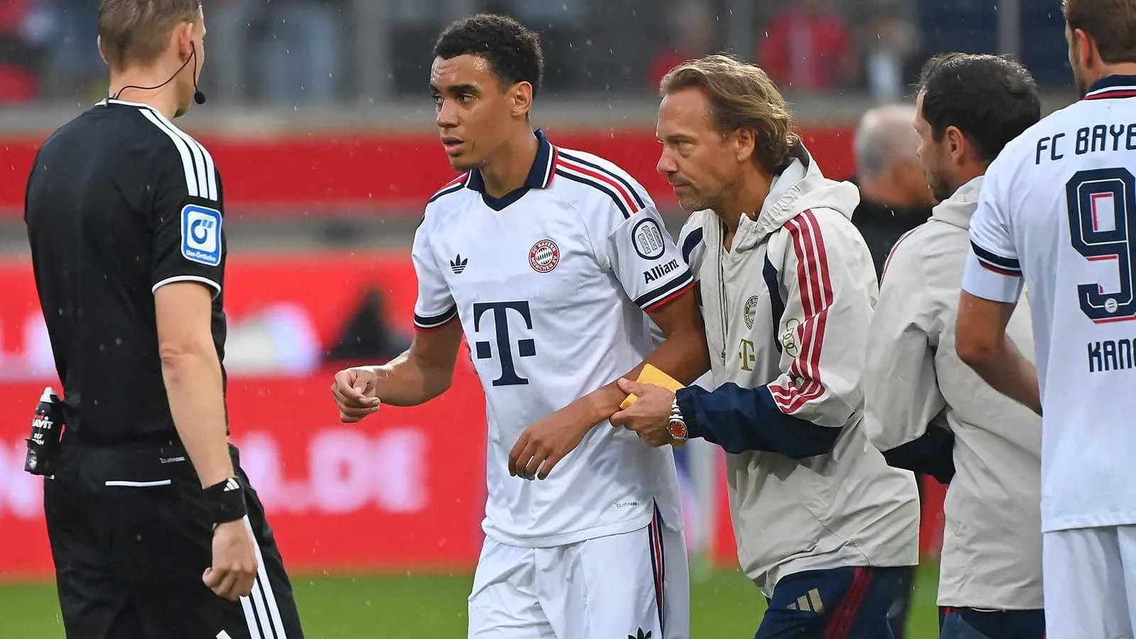 Player receiving instructions from staff during match Player receiving instructions from staff during match