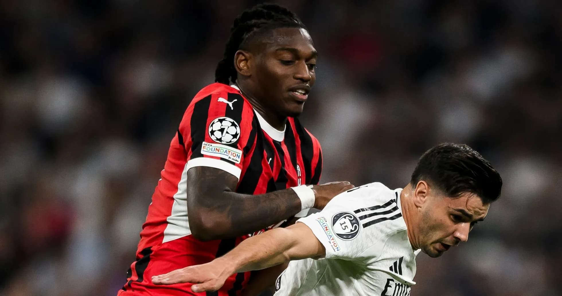 Player in red and black jersey pushing opponent in white Player in red and black jersey pushing opponent in white