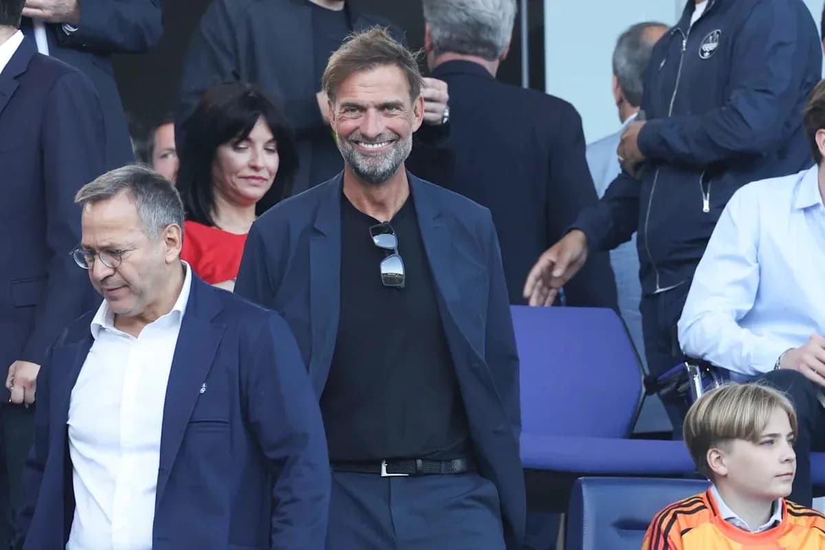 Two men walking in a stadium with spectators Two men walking in a stadium with spectators