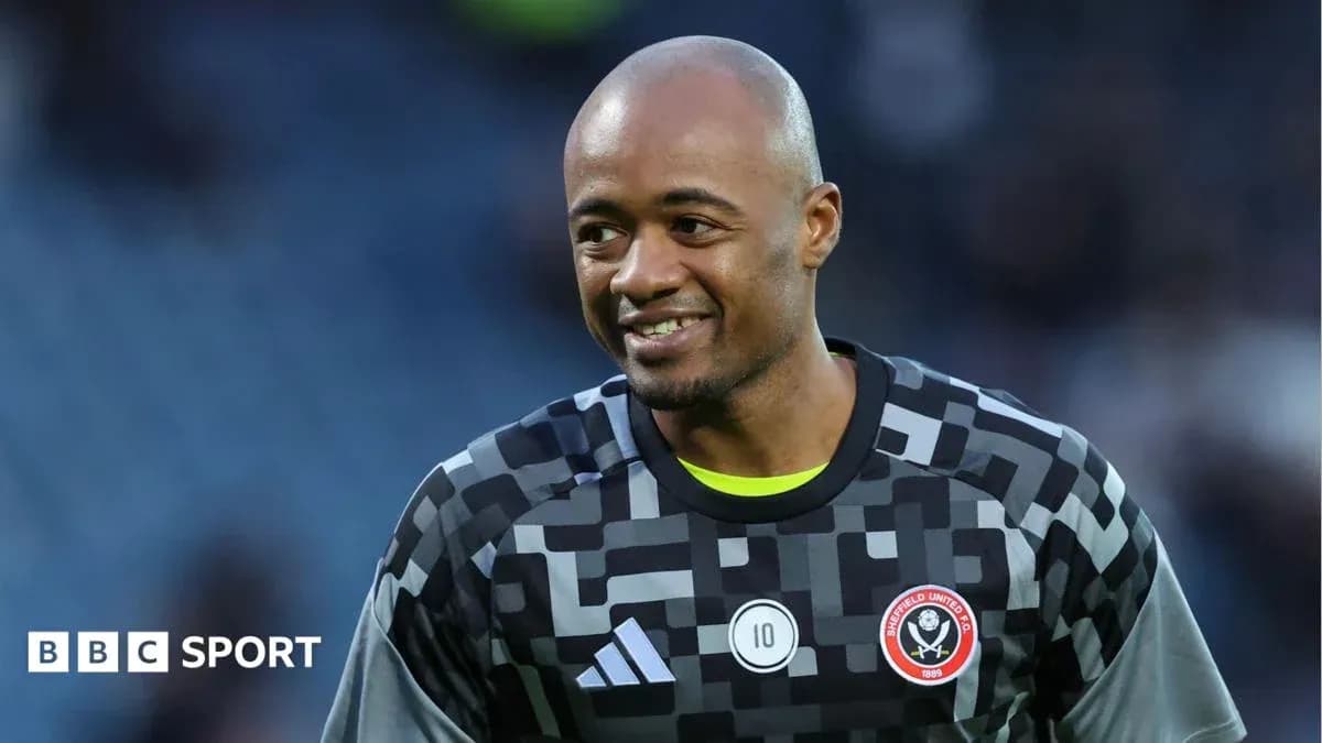Goalkeeper in Sheffield United kit smiling on field Goalkeeper in Sheffield United kit smiling on field